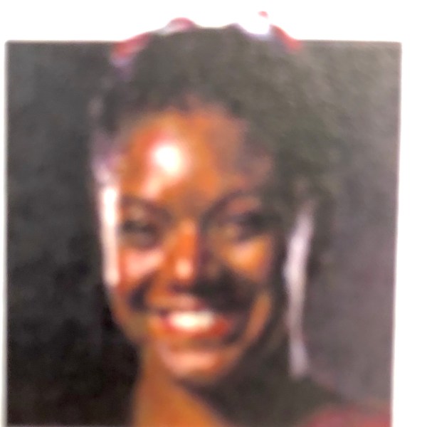 a person who is smiling and looking at the camera