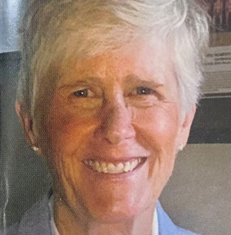 Carol Callan a woman wearing a suit and tie smiling at the camera