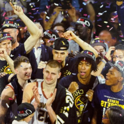 a group of basketball players in front of a crowd