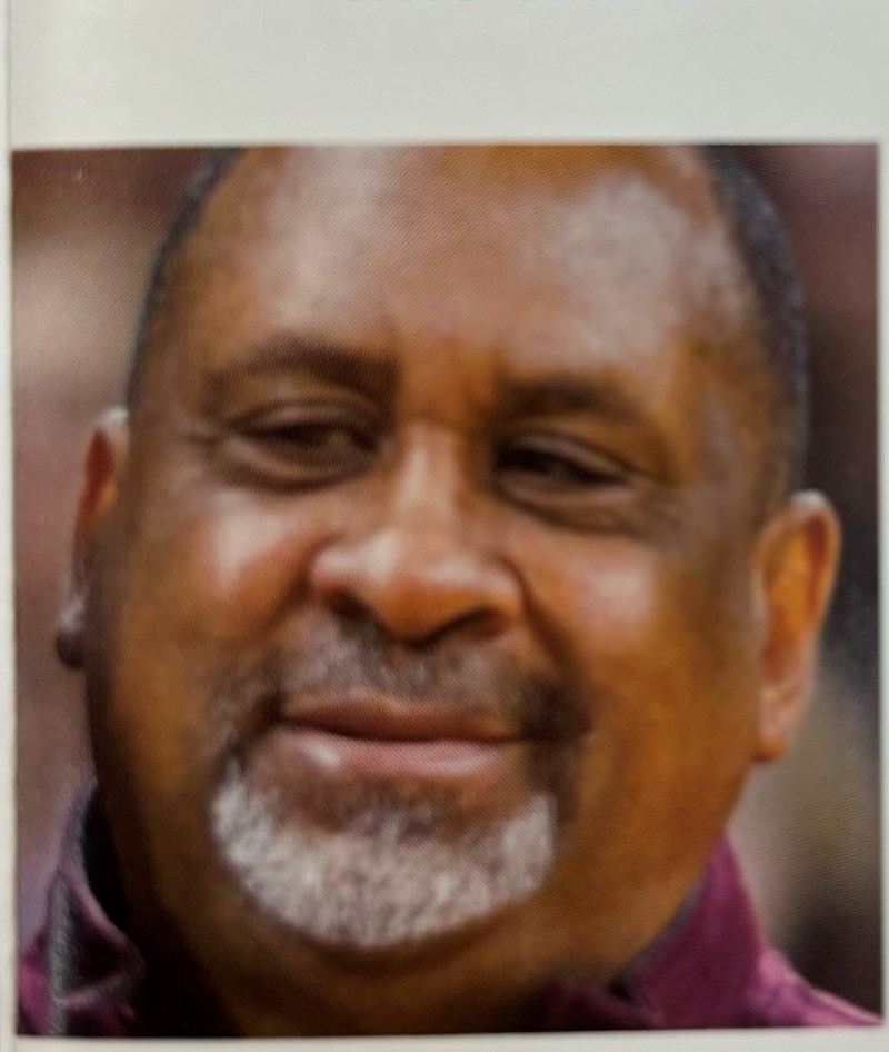 a close up of a man who is smiling and looking at the camera