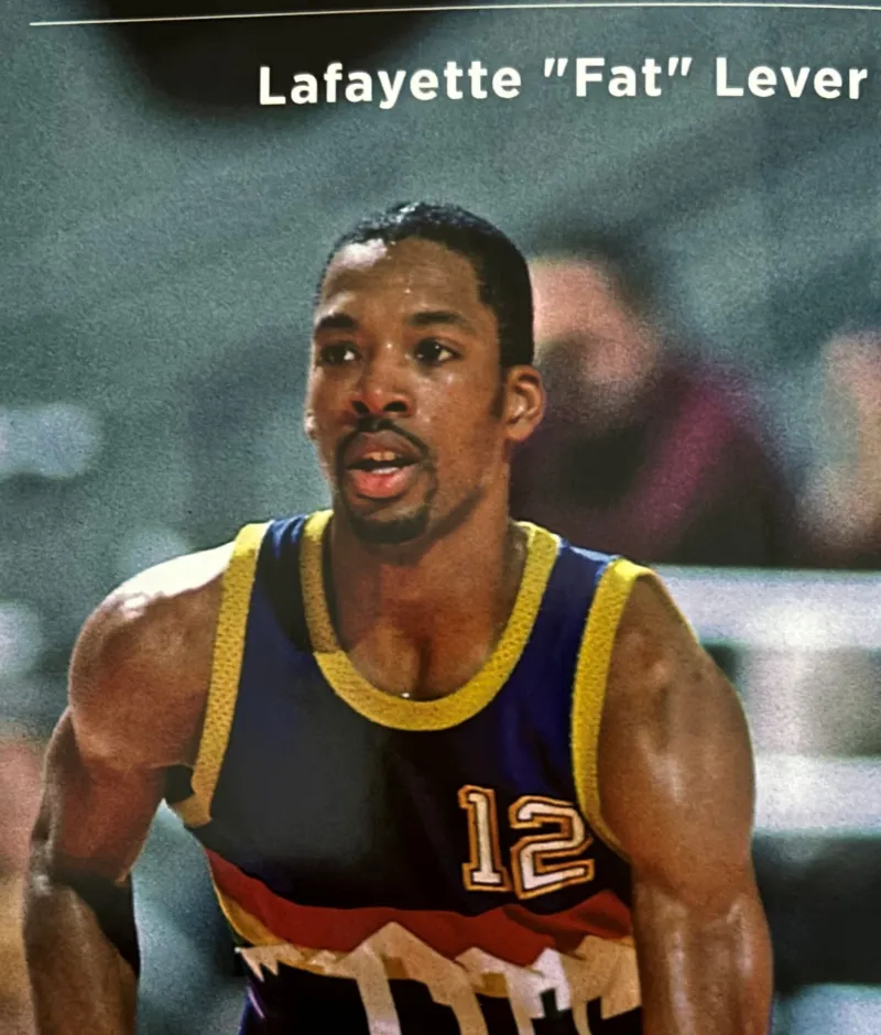 Basketball player in a colorful jersey with number 12 during a game.